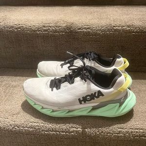 Super Cool Hoka white Pro Fly sneakers with lime green sole.